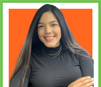 SERVPRO employee Maria Urdaneta wearing zip-up jacket