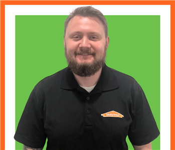 Chad, SERVPRO employee against green backdrop, male